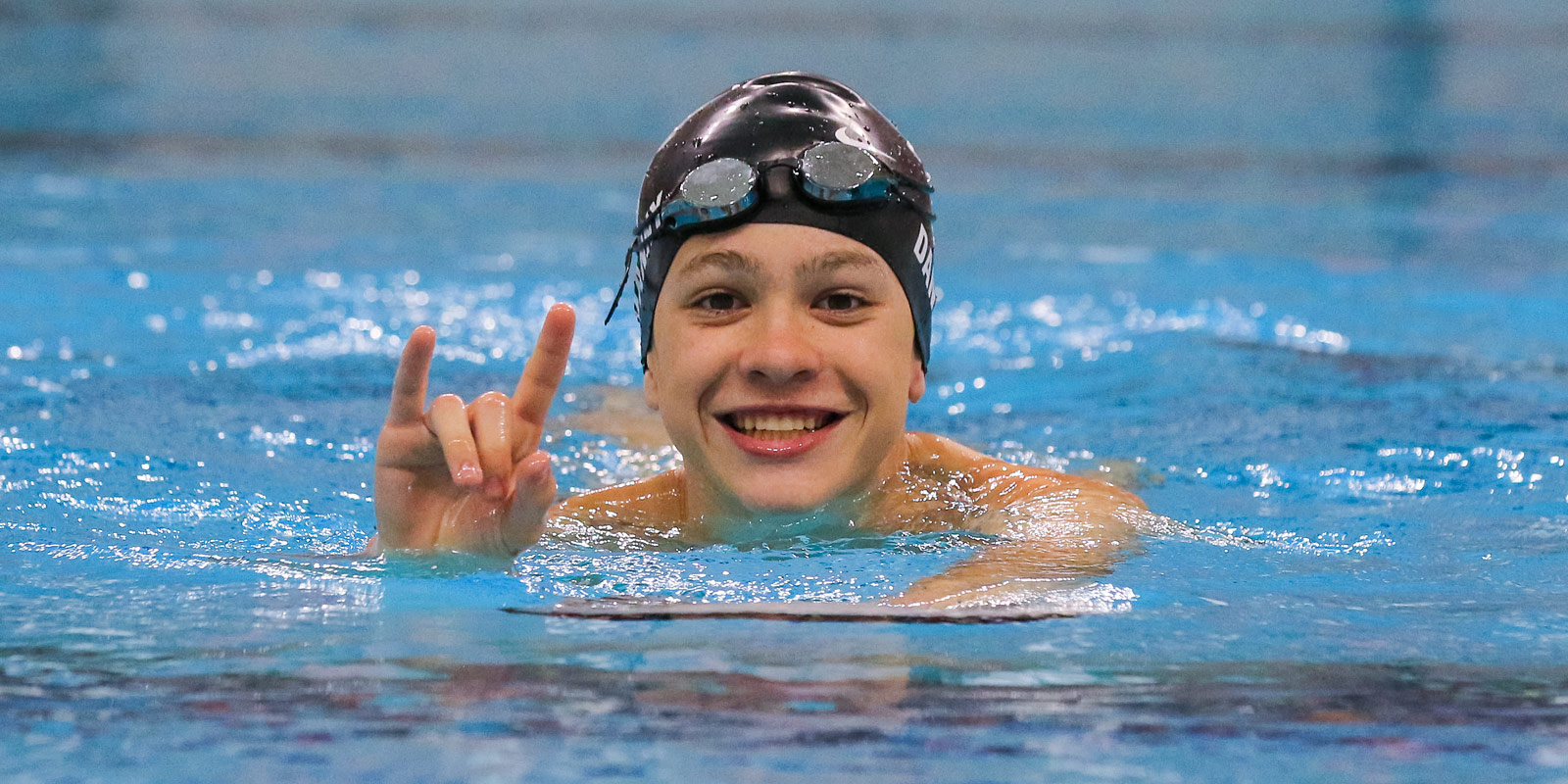 A young swimmer shows his Longhorn pride