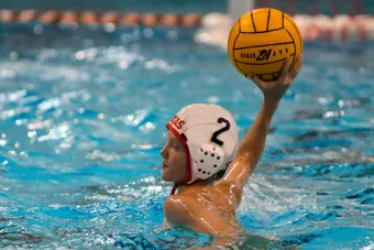 boy playing water polo, about to throw ball