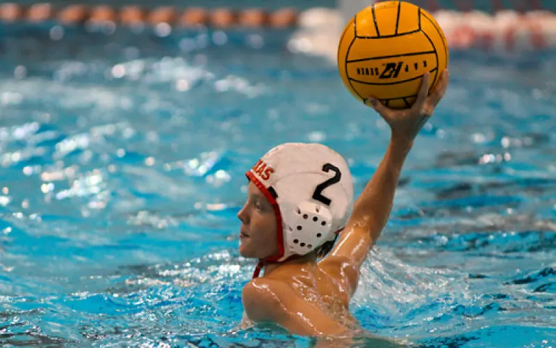 boy playing water polo, about to throw ball