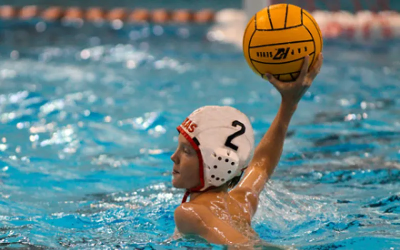 boy playing water polo, about to throw ball